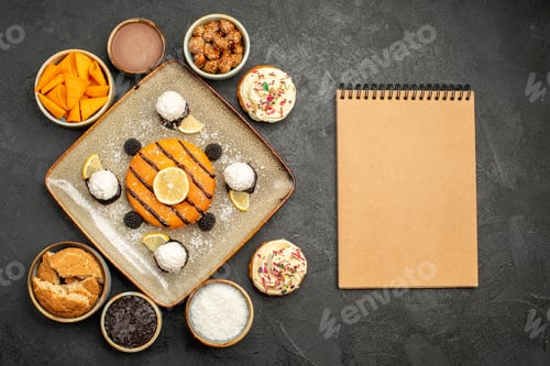 Preview: top view delicious little cake with coconut candies on a dark-grey background cake dessert biscuit