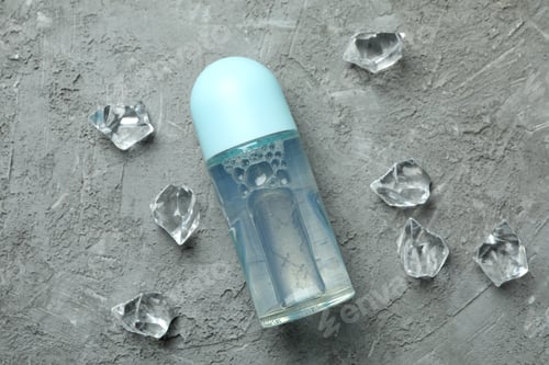 Preview: Blank deodorant and ice cubes on gray textured background