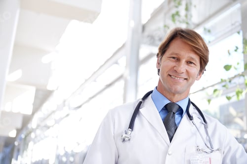 Preview: Healthcare. A medical doctor standing in a hospital corridor.