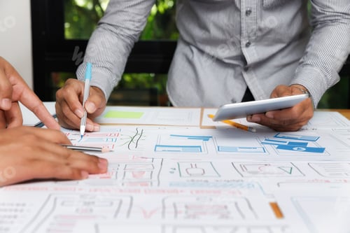 Preview: UX or UI designers designing on their smartphone application layout prototype project.