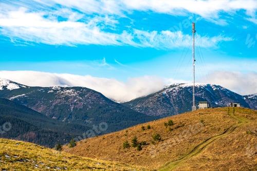 Preview: Telecommunication tower against the backdrop of an awesomely beautiful sky with blurry snow-white
