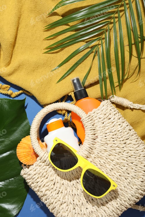 Preview: Beach accessories and palm leaves on blue background, flat lay