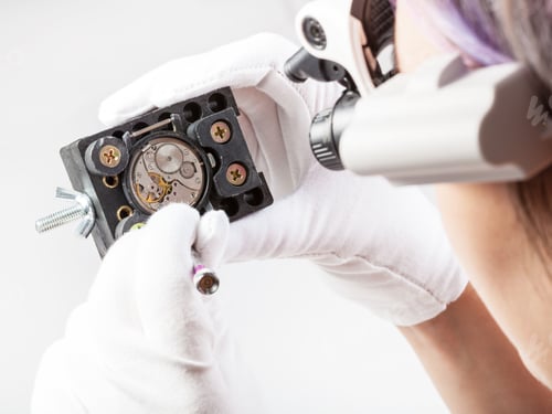 Preview: watchmaker in lenses repairs old wristwatch