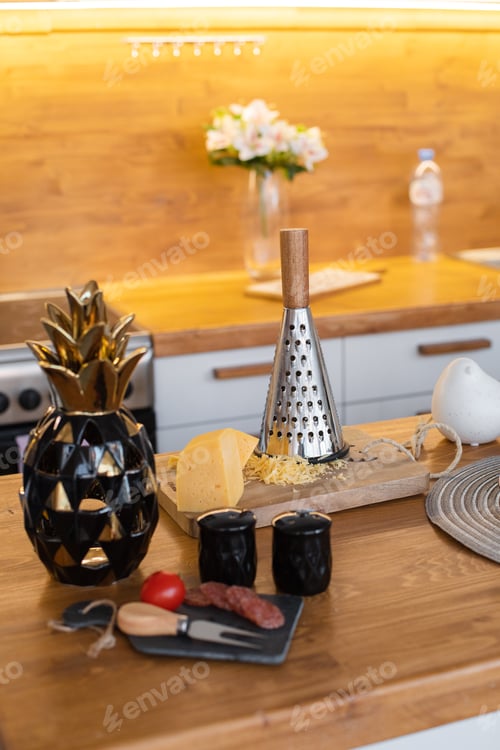 Preview: Cheese and grater on cutting board in the kitchen