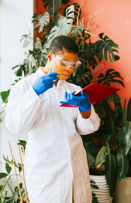 Preview: african american woman student intern with conducts an experiment
