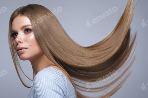 Preview: Beautiful blond girl with a perfectly smooth hair, and classic make-up. Beauty face and hair.