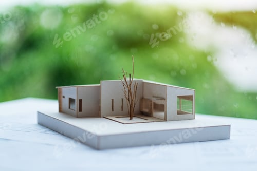 Preview: An architecture model with shop drawing paper on table in office with blur nature background