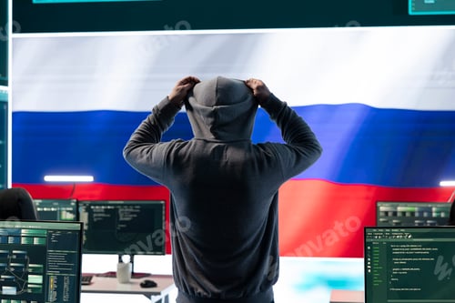 Preview: Russian hacker with a hood installing panic by misconception and manipulation
