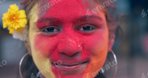 Preview: Closeup shot of a smiling Sout Asian female during celebrations of Festival of Colours