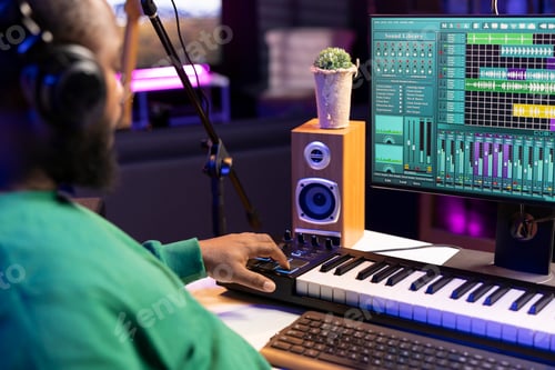 Preview: Music engineer adding synthesizer notes over his audio files in home studio