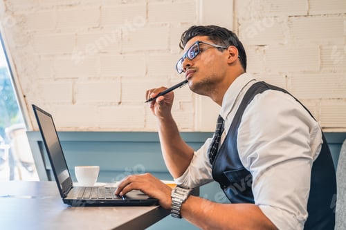 Preview: Man working on a laptop in cafe