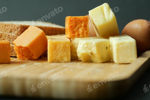 Preview: Cheese cubes green, yellow and red color on chopping board