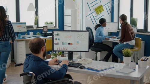Preview: Paralized employee talking with african team leader woman sharing information