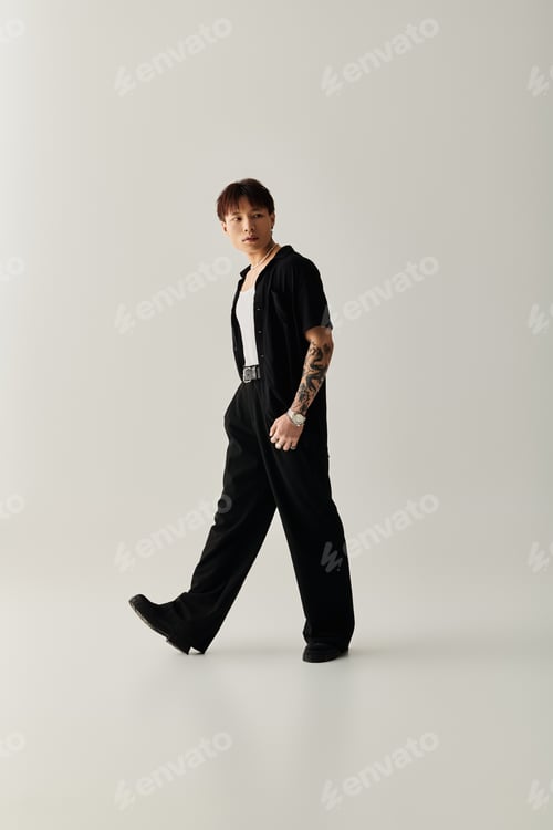 Preview: Stylish Asian man walking confidently in a modern, minimalist studio setting