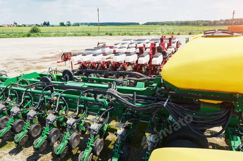 Preview: Close up of seeder attached to tractor in field. Agricultural machinery for spring works sowing