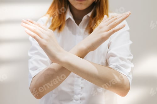 Preview: teenage girl generation Z with her arms crossed at her chest demonstrates Break The Bias symbol of i