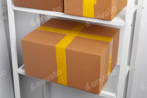 Preview: Stack of cardboard package boxes on wooden rack
