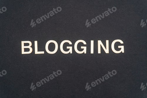 Preview: BLOGGING word written on dark paper background. BLOGGING text for your concepts