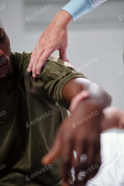 Preview: Doctor Examining Arm of Soldier