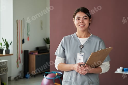 Preview: Portrait of Female Nurse Smiling and Holding Clipboard