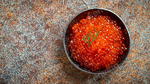 Preview: Delicious red caviar in black bowl.