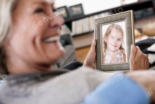 Preview: Germany, Wakendorf, Grandparents holding granddaughter photograph