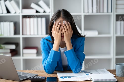 Preview: Stressed puzzled Asain businesswoman sitting in office room, burnout, overworked concept.