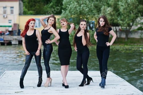Preview: Five beautiful young sexy girls models in black tight dress posing on pier
