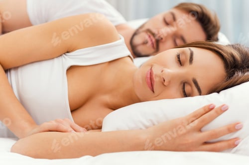 Preview: Sweet dreams. Beautiful young loving couple sleeping together in bed