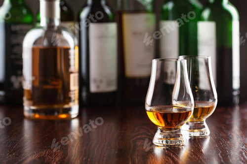 Preview: Bottles and glass of whisky spirit brandy on dark brown background