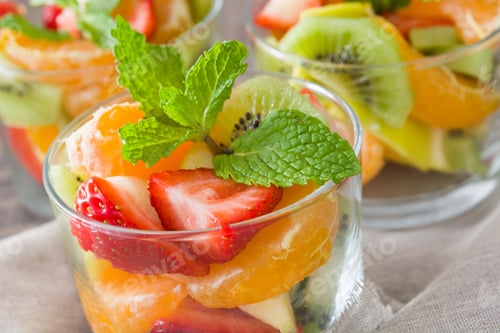 Preview: Fresh fruit salad with mandarin, kiwi and strawberry garnished with mint