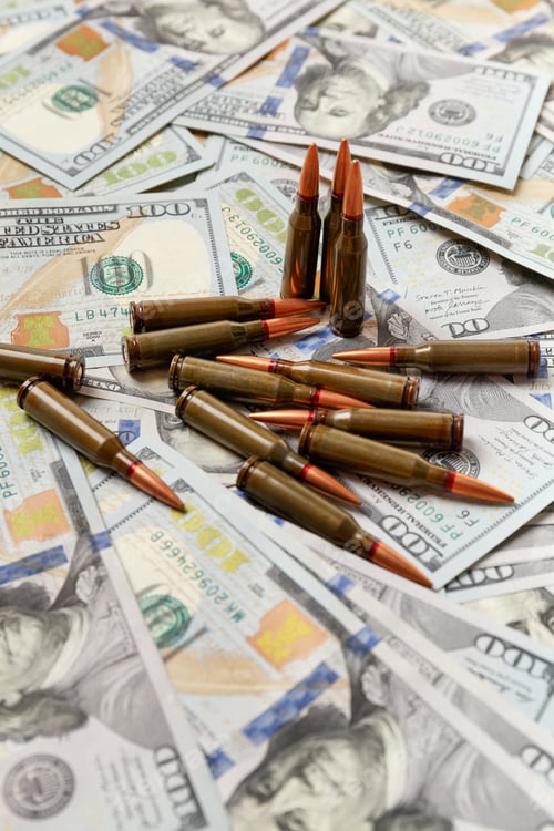 Preview: Bullets lie on American dollar bills, arms trade