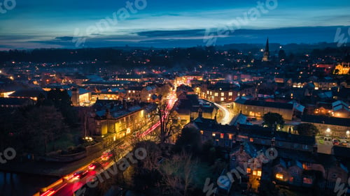 Preview: Charming town at dusk with vibrant streetlights.