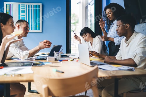 Preview: Thoughtful partners doing paperwork in office