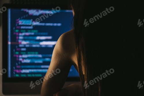 Preview: Young female programmer writes program code on a computer. home office