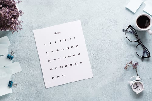 Preview: Blank sheet of monthly calendar, glasses, coffee cup and alarm clock on the desktop.