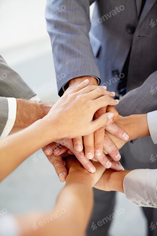 Preview: Cropped view of businesspeoples hands indicating unity
