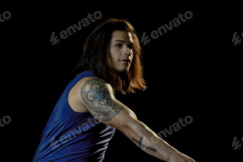Preview: Portrait of young man pitching, black background