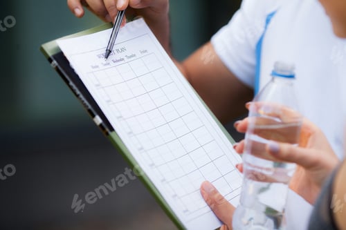 Preview: Fitness plan. Sports trainer amounts to workout plan close-up