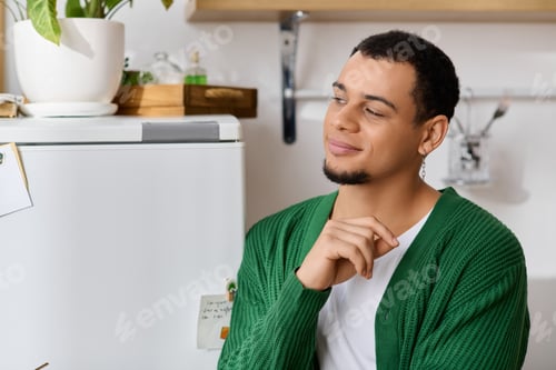 Preview: Handsome young man enjoying a serene moment in a cozy home setting filled with warmth