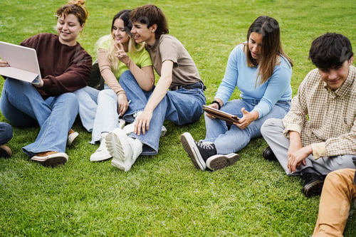 Preview: Young friends studying together outdoor sitting in university park - Focus on right girl face