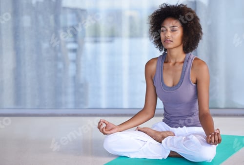 Preview: Finding inner peace. Shot of an attractive young woman meditating on an exercise mat.