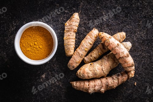 Preview: Indian turmeric powder and root. Turmeric spice. Ground turmeric.