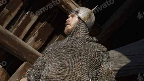 Preview: Close up of a warrior in chainmail armor whistling with his fingers. Media. Ancient warrior nea