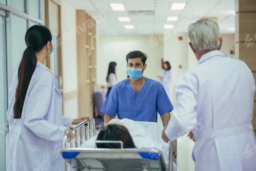 Preview: Paramedics carrying patient on gurney pushing and running towards the operating room