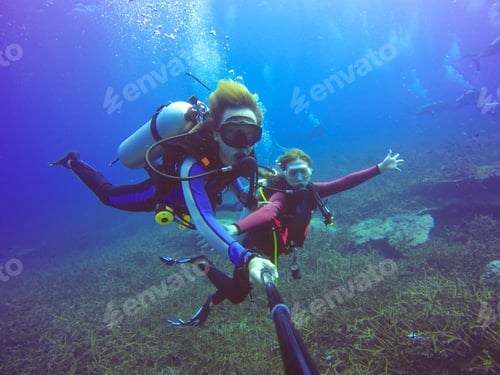 Preview: Underwater scuba diving selfie shot with selfie stick. Deep blue sea. Wide angle shot.