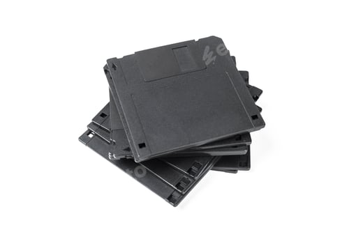 Preview: Old storage disks stacked on a flat surface in a simple arrangement in a bright setting