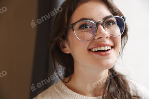 Preview: Image of young caucasian woman wearing eyeglasses smiling in cafe