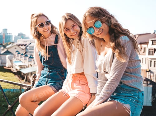 Preview: Portrait of three young beautiful women posing outdoors