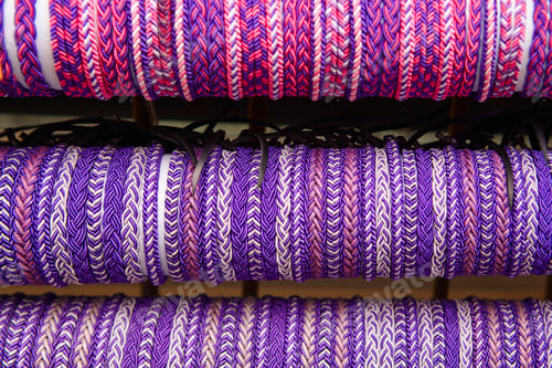 Preview: Ultra violet wristbands. Purple textured background. Hand made. Horizontal
